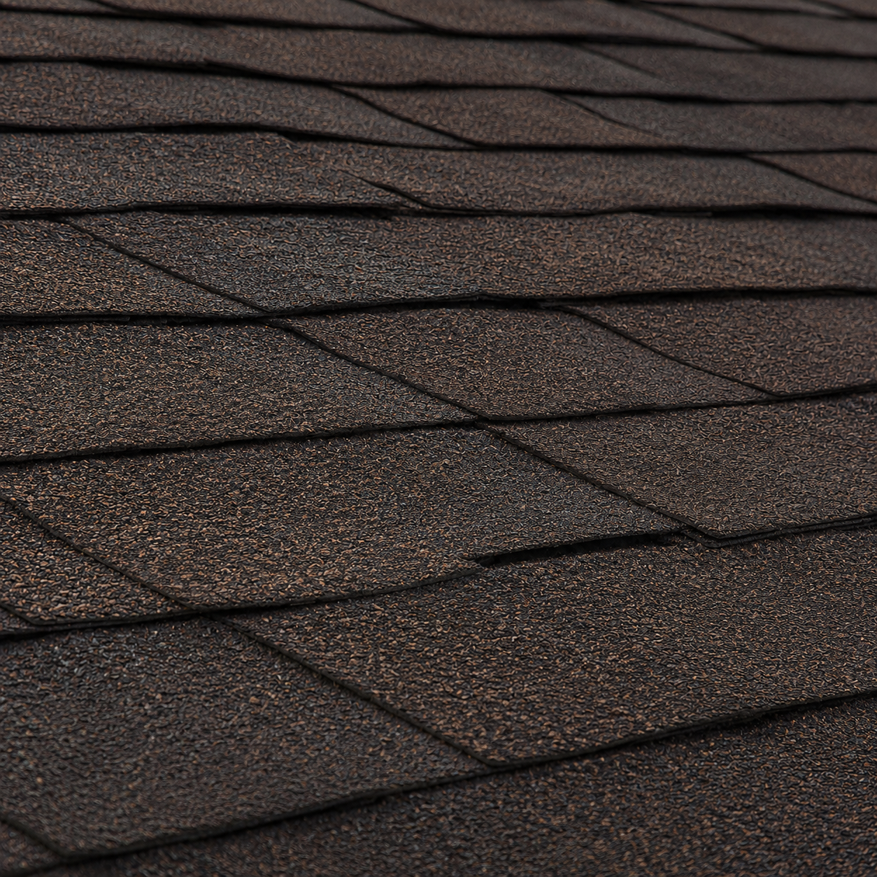 The same asphalt shingles after rejuvenation, supple, richer in color, and restored